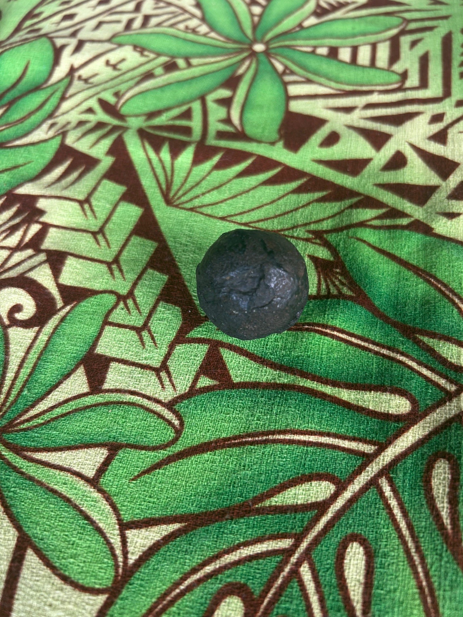 Metallic nodule pictured on table cloth, courtesy of C.M. and Tisa Fa’amuli