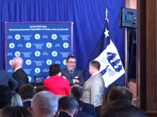 Amata speaks with officials before the event