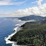 A 2019 coastal view of American Samoa with mountainous tropical forest