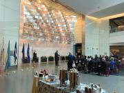 The original Star Spangled Banner from the War of 1812 is displayed in a darkened room just behind this backdrop