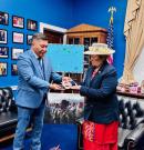 Kaneko presenting Amata a traditional gift