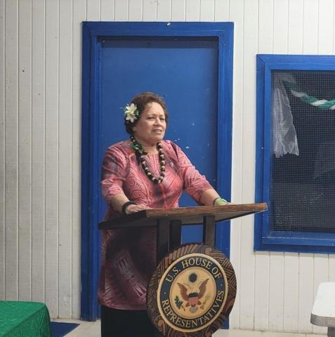 Amata at podium in the town hall