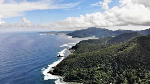 A 2019 coastal view of American Samoa with mountainous tropical forest