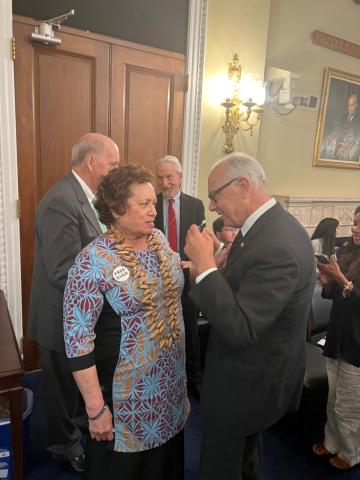 Congresswoman Amata conversing with Dr. Watson during a break in the hearing