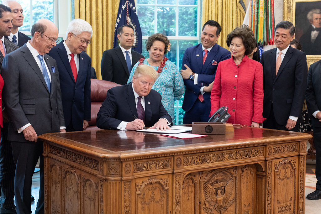 Congresswoman Amata looking on as the President signs the Executive Order