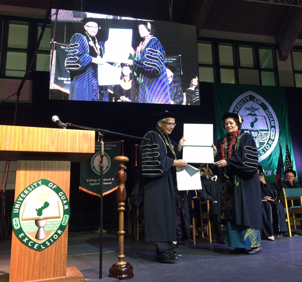 Dr. Underwood presenting the doctorate to Congresswoman Amata.