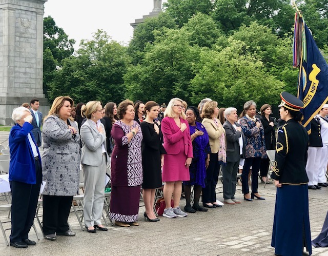 Members of Congress with hands over hearts at Women in the Military Memorial