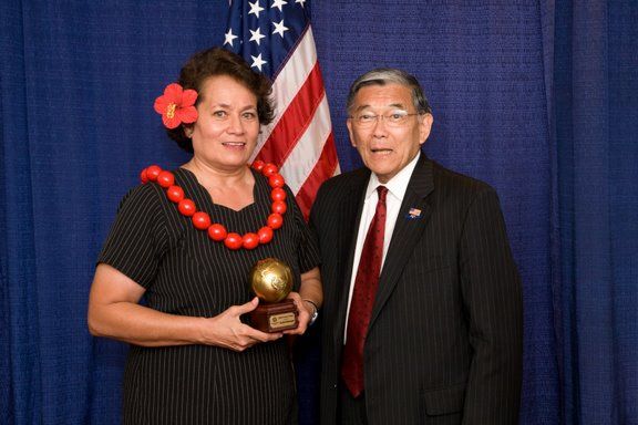 Aumua is presented an AAPI Leadership Award by former U.S. Commerce Secretary Norman Mineta
