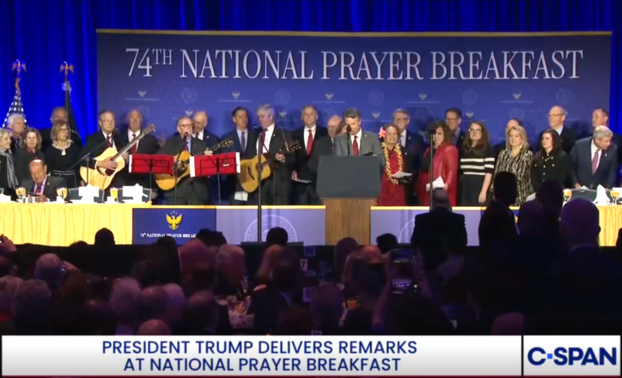 Prayer Breakfast Members Choir with Congresswoman Amata near the center podium.